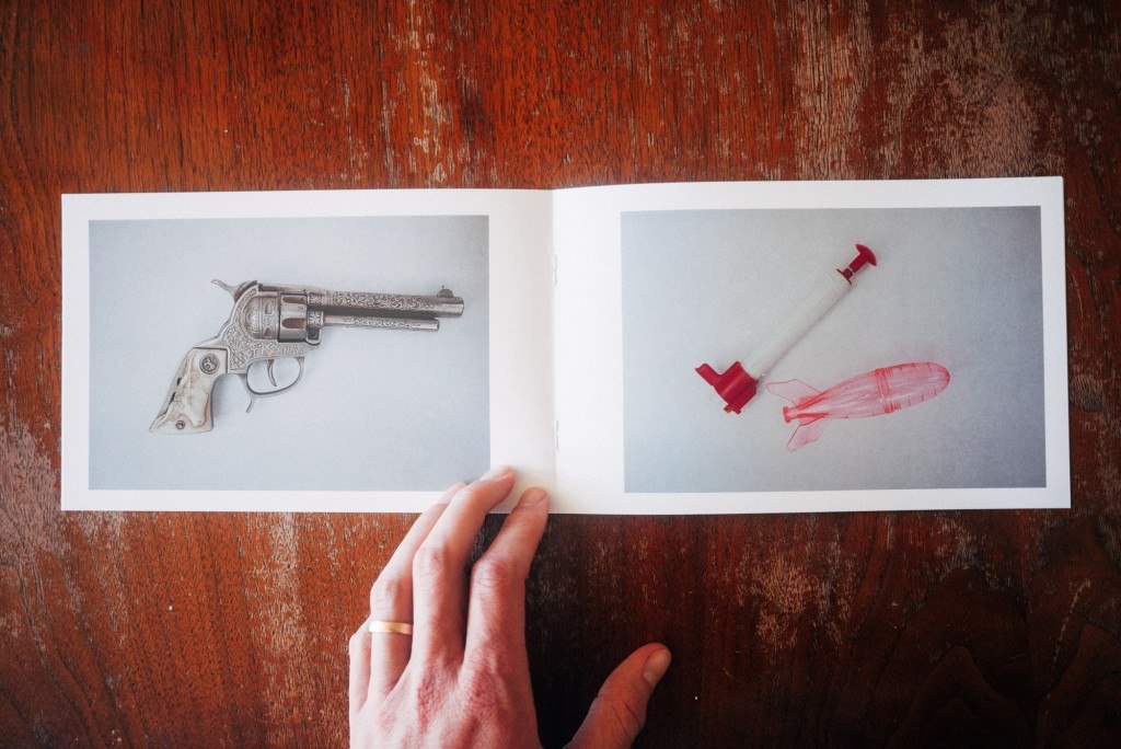 A spread from “Toys, Guns, and Fireworks” a book cataloging vintage toys from Brown’s childhood home.