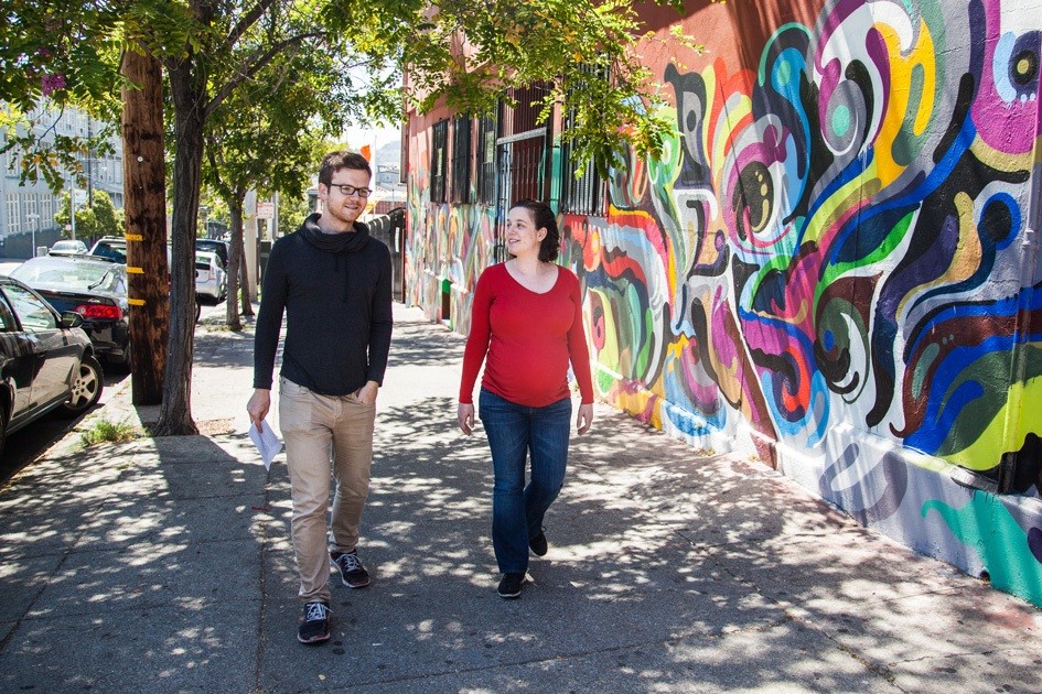 Many meetings are done on foot, walking around the sunny and colorful neighborhood.