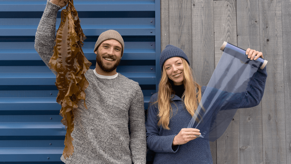 Co-founders Matt Mayes and Julia Marsh holding seaweed and a roll of Sway plastic film. Credit: Sway.